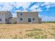 A spacious backyard featuring a gray home with bright white trim and glass sliding doors at 14412 Heritage Dr, Mead, CO 80504