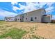Spacious backyard featuring a gray home with bright white trim, and sliding glass doors at 14412 Heritage Dr, Mead, CO 80504