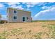 A spacious backyard featuring a gray home with bright white trim and glass sliding doors at 14412 Heritage Dr, Mead, CO 80504