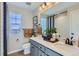 Bright bathroom features double vanity, window with a view, and a shower at 14412 Heritage Dr, Mead, CO 80504
