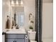 Well-lit bathroom showcasing a modern vanity, neutral decor, and sleek fixtures at 14412 Heritage Dr, Mead, CO 80504