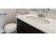 Modern bathroom features a sleek vanity with quartz countertop, chrome faucet, and a white toilet at 14412 Heritage Dr, Mead, CO 80504