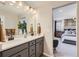 Bright bathroom features double vanity, wood floors, and neutral decor at 14412 Heritage Dr, Mead, CO 80504