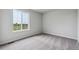 Bedroom featuring neutral carpeting, a large window with a view, and freshly painted walls at 14412 Heritage Dr, Mead, CO 80504