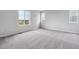 This expansive bedroom features soft carpet and large windows for ample natural light at 14412 Heritage Dr, Mead, CO 80504