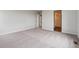Spacious bedroom with neutral walls, plush carpet, and multiple entryways at 14412 Heritage Dr, Mead, CO 80504