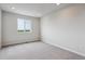 A bright and airy bedroom with neutral carpeting and a large window, providing ample natural light at 14412 Heritage Dr, Mead, CO 80504