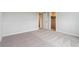 Bright bedroom featuring neutral carpeting, a large open closet, and freshly painted walls at 14412 Heritage Dr, Mead, CO 80504