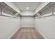 Walk-in closet featuring plush carpet and metal racks for storage at 14412 Heritage Dr, Mead, CO 80504