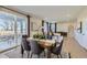 Open dining area with a table set for six, sliding glass doors leading to the patio, and natural light at 14412 Heritage Dr, Mead, CO 80504