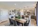 Elegant dining room with gray upholstered chairs, a rustic wooden table, and stylish pendant lighting at 14412 Heritage Dr, Mead, CO 80504
