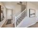 Inviting entryway with a staircase, light wood floors, and neutral decor. Door leads to the exterior at 14412 Heritage Dr, Mead, CO 80504