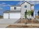 Charming two-story home boasts a two-car garage, neutral siding, and a well-manicured front yard, perfect for suburban living at 14412 Heritage Dr, Mead, CO 80504