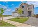 Attractive gray home boasting a three-car garage, front yard with young trees, and easy access via a sidewalk at 14412 Heritage Dr, Mead, CO 80504