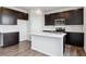 Kitchen boasts modern, dark cabinetry, stainless steel appliances, and a center island with white countertop at 14412 Heritage Dr, Mead, CO 80504