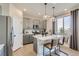 Modern kitchen with gray cabinets, white countertops, stainless steel appliances, and pendant lighting at 14412 Heritage Dr, Mead, CO 80504