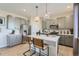 Modern kitchen features gray cabinetry, stainless steel appliances, and a center island with bar seating at 14412 Heritage Dr, Mead, CO 80504