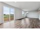 Bright, open living space features stylish wood-look floors and large windows providing scenic views of the outdoors at 14412 Heritage Dr, Mead, CO 80504