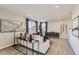 Comfortable living room with a large sofa, modern art, and stylish decor in neutral tones at 14412 Heritage Dr, Mead, CO 80504