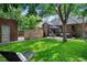 Lush backyard featuring a well-maintained lawn, patio seating area, and privacy fence for outdoor enjoyment at 1040 S Elizabeth St, Denver, CO 80209