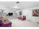 Finished basement with carpet flooring, built-in shelves, and bright lighting at 1040 S Elizabeth St, Denver, CO 80209