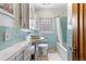Stylish bathroom with unique sink, updated fixtures, and classic tile design at 1040 S Elizabeth St, Denver, CO 80209