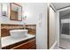 Charming bathroom with modern vessel sink, mosaic tile backsplash, updated fixtures and convenient shower at 1040 S Elizabeth St, Denver, CO 80209