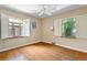 Sunny bedroom with wood floors, and two large windows with backyard views at 1040 S Elizabeth St, Denver, CO 80209