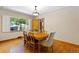 Dining room featuring a wood table, a window letting in natural light, and hardwood floors at 1040 S Elizabeth St, Denver, CO 80209