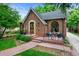 Beautiful brick home with manicured lawn, covered porch, and an arched window, enhancing its charm at 1040 S Elizabeth St, Denver, CO 80209