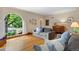 Bright living room with an arched window view, hardwood floors, and a comfortable seating arrangement at 1040 S Elizabeth St, Denver, CO 80209
