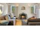 Inviting living room with a tiled fireplace, hardwood floors, and windows providing ample natural light at 1040 S Elizabeth St, Denver, CO 80209