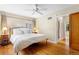 Serene main bedroom with hardwood floors, a ceiling fan, and ample natural light at 1040 S Elizabeth St, Denver, CO 80209