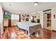 Spacious finished basement featuring hardwood flooring, a pool table, and ample entertainment space at 838 S 10Th Ave, Brighton, CO 80601