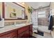 Well-lit bathroom featuring a vanity with granite countertop and tiled shower-tub combination at 838 S 10Th Ave, Brighton, CO 80601