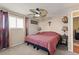 Cozy bedroom featuring a ceiling fan, plush carpet, and large window for natural light at 838 S 10Th Ave, Brighton, CO 80601