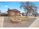 Well maintained brick two-story home featuring a cozy firepit and gravel landscaping at 838 S 10Th Ave, Brighton, CO 80601
