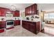Well-equipped kitchen with wood cabinetry, stainless steel appliances, and tile flooring at 838 S 10Th Ave, Brighton, CO 80601