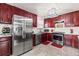 Modern kitchen with stainless steel appliances, dark wood cabinets, and tile flooring at 838 S 10Th Ave, Brighton, CO 80601
