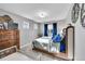 Bedroom with soft carpet, light grey walls, and windows that offer a view of the neighborhood at 8492 Arriba Dr, Littleton, CO 80125