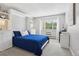 Bright bedroom with built-in shelving, storage, and a serene window view, creating a cozy retreat at 3465 S Poplar St # 305, Denver, CO 80224