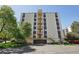 Multi-story building exterior showing the parking and surrounding landscape features at 3465 S Poplar St # 305, Denver, CO 80224