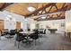 Bright community game room featuring tall wood ceilings, multiple tables and chairs, and a billiards area at 3465 S Poplar St # 305, Denver, CO 80224