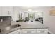 Modern kitchen overlooks the living room and includes granite counters and stainless steel sink at 3465 S Poplar St # 305, Denver, CO 80224