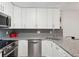 Bright kitchen features stainless steel appliances, granite counters and white cabinets at 3465 S Poplar St # 305, Denver, CO 80224