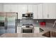 Modern kitchen featuring stainless steel appliances, granite countertops, and sleek finishes at 3465 S Poplar St # 305, Denver, CO 80224