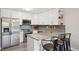 Updated kitchen features white cabinetry, granite countertops, and stainless steel appliances at 3465 S Poplar St # 305, Denver, CO 80224