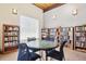 Cozy library with bookshelves filled with books, a large window, and a round table with chairs at 3465 S Poplar St # 305, Denver, CO 80224