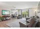 Open-concept living room with comfortable furniture, balcony access, and sleek flooring at 3465 S Poplar St # 305, Denver, CO 80224