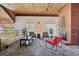 Inviting lounge area featuring a brick fireplace, plush seating, and wood-paneled ceilings at 3465 S Poplar St # 305, Denver, CO 80224